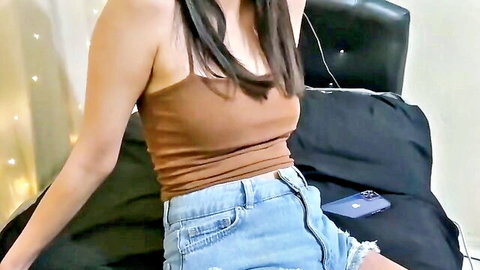 Young Turkish brunette in tight mini jeans shorts and crop top