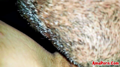 Close-up of bearded man licking woman's hairy pussy in explicit oral sex scene