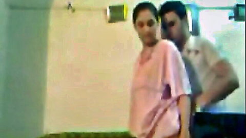 Hot Indian girlfriend in pink top hugged intimately from behind by boyfriend in bathroom