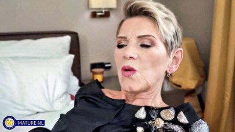 Blonde MILF Irenka in provocative pose in black dress