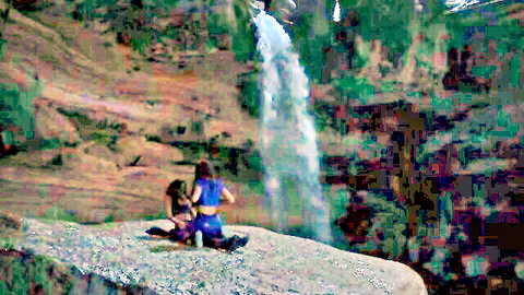 Irene Dev and Nona Sobo in bikinis by waterfall in Welcome to Eden nude scenes