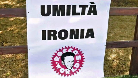 Rocco Siffredi Umiltà Ironia banner in outdoor Bologna porn event scene
