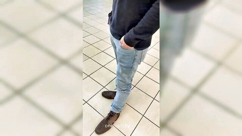 Slim guy in tight blue jeans and brown leather boots, hands in pockets