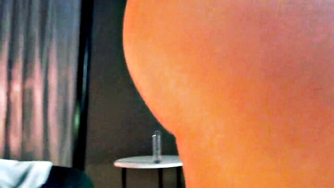 Closeup of massive round tanned ass bent over nude in bedroom teasing doggy