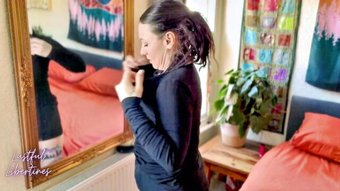 Lustful Libertines poses seductively in black mini dress before mirror