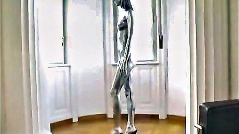 Silver painted nude woman posing as alive doll, craving sex