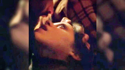 Brunette woman passionately kissing man in close-up intimate embrace