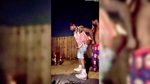 Two black muscular men in shorts posing suggestively outdoors on July 4th