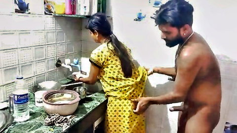 Indian woman in yellow dress fucked from behind in kitchen by naked man