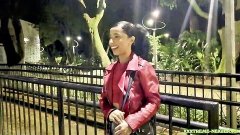 Smiling Latina in sexy red leather jacket outdoors at night, XXXTREME NEIGHBORS