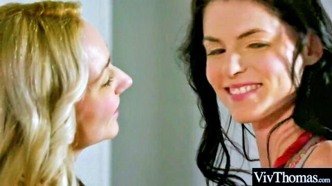 Blonde and brunette lesbians smiling intimately in close-up