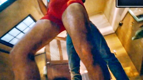 Man in jeans grabbing partner's red-clad crotch in intense M/M encounter