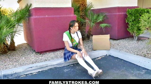 Sami Parker as sexy Asian schoolgirl in stockings sitting outside with box