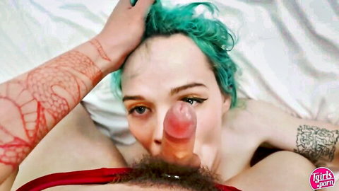 Petite teal-haired trans babe with tattoos deepthroating pink cock on bed