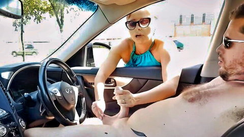 Blonde cougar helps guy stroke penis in van handjob scene