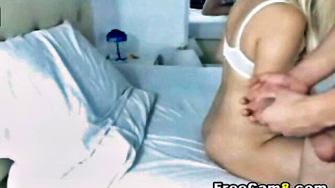 Husband grabs blonde wife's bare ass on bed while wearing white bra, hard cock ready to fuck her pussy from behind