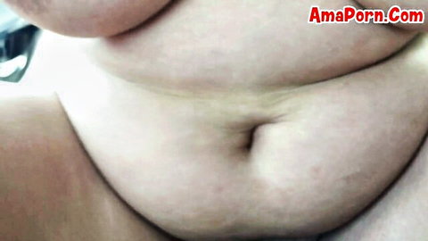 Close-up of chubby woman's fat belly, deep navel and hairy pussy mound