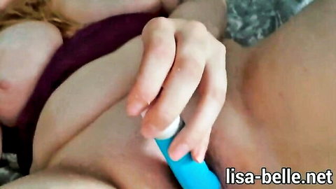 Busty babe masturbates shaved pussy with blue vibrator toy closeup