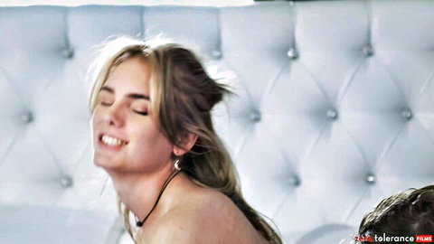Blonde with big tits smiles in ecstasy wearing choker necklace nude on white bed