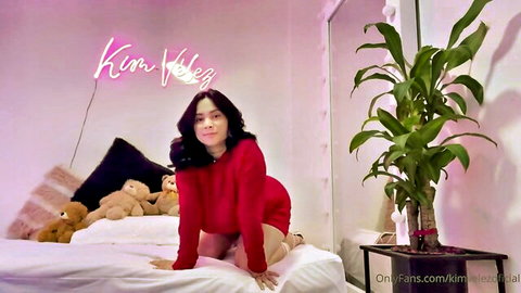 Curvy brunette in red dress poses seductively on bed in hot solo video