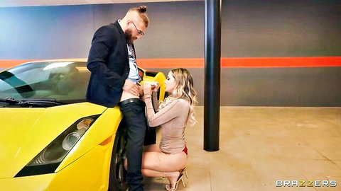 Kenia Music kneeling blowjob on suited man by luxury car in Brazzers