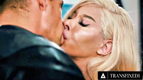 Passionate kiss between bearded man and blonde trans woman in leather jacket