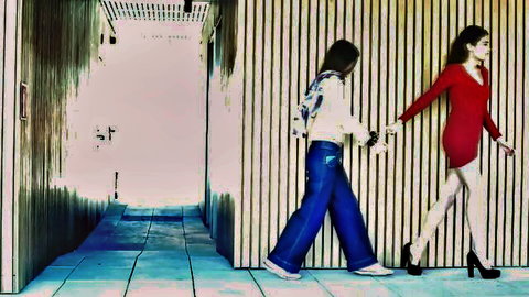 Penelope Cum and Arian hold hands in hallway, red dress tease