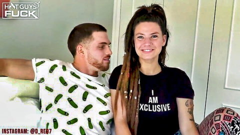Dreadlocked tattooed woman smiles with guy in pickle tee, casual couple vibe