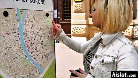 Blonde woman in white jacket pointing at city map, teasing hard cumshot action