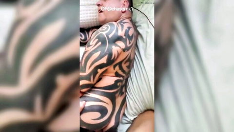Mature beefy tattooed bear lying in bed, verbal gay fuck scene