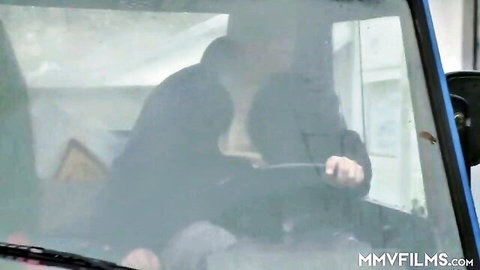 Blurry couple passionately kissing and embracing in foggy car window