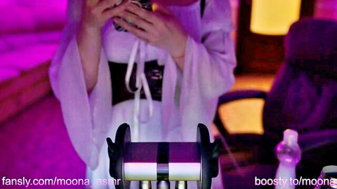 Moon ASMR in white flowing lingerie with black corset, holding phone seductively