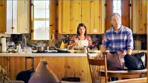 Woman in apron cooking in kitchen with man nearby, Double Eagle Ranch (2018)