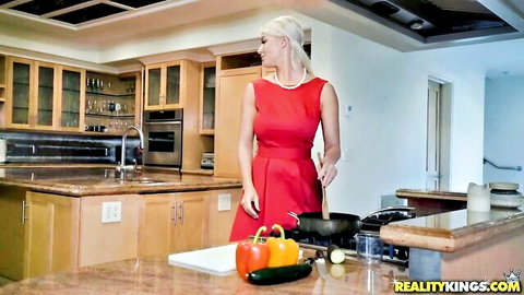 Blonde in tight red dress cooking veggies in kitchen tease
