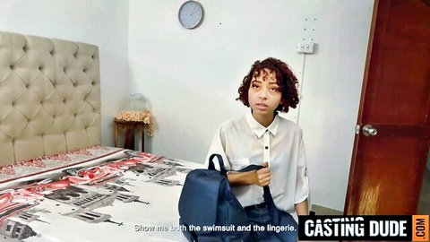 Curly-haired Colombian teen in white shirt during swimsuit lingerie casting