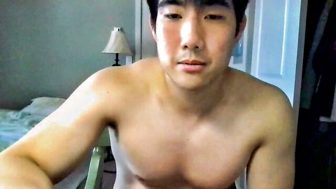 Shirtless muscular Asian hunk posing in gay amateur video