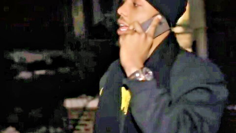 Ebony man in beanie and jacket on phone outdoors, teasing hotel fuck preview