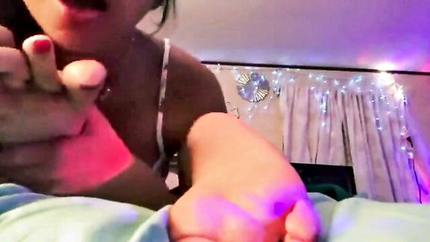 Asian woman's bare feet worshipped by hands in white lingerie POV