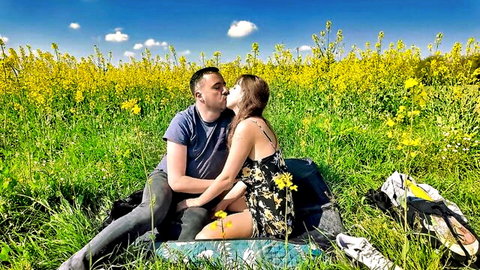 Romantic couple kissing in sunny flower field, outdoor doggy style tease