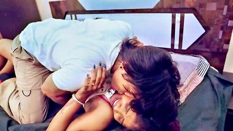 Passionate Indian couple in steamy kiss with man on top pinning sexy woman on bed