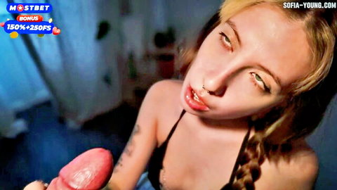 Tattooed blonde with pierced lip giving intense blowjob close-up