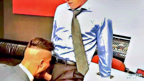 Bearded suited man kneels to suck cock of standing executive in shiny shirts and ties office studio