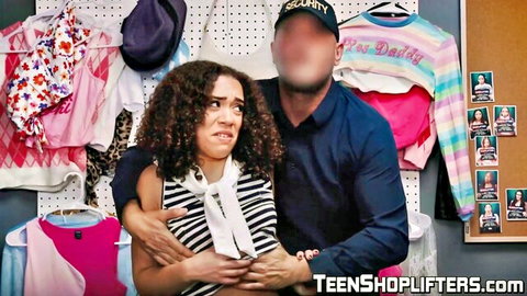 Security guard holds scared curly-haired brunette teen shoplifter from behind in store room