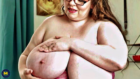 Curvy BBW with glasses and huge breasts cupping them topless solo