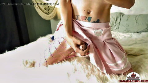 Canadian trans cheerleader lifts pink skirt holding her hard cock on furry bed