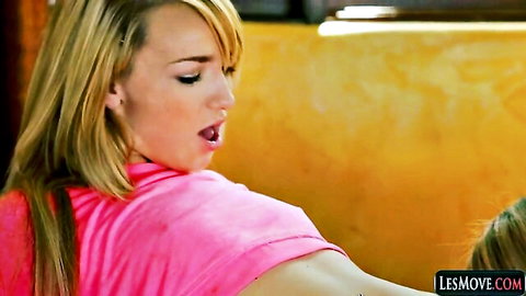 Blonde lesbian in pink top moans ecstatically with mouth open in pleasure