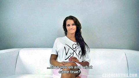 Amateur brunette girl in casting interview, smiling in white crop top and pink shorts