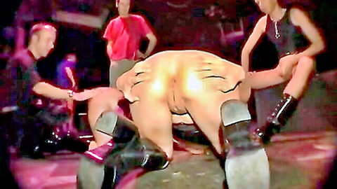 Extreme big tit fuck toy scene with bent-over model in boots and fetish gear