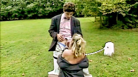 Béatrice Valle in vintage French porn: blonde on knees giving outdoor blowjob to suited man