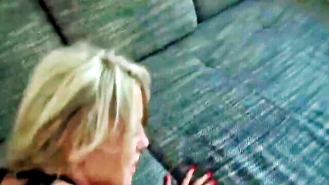 Blonde MILF moans in ecstasy on green couch with red nails visible